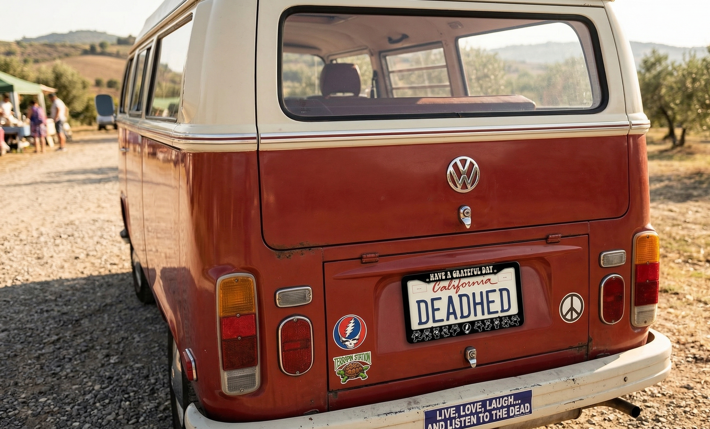 Red Volkswagen van with 'DEADED' license plate in a rural setting